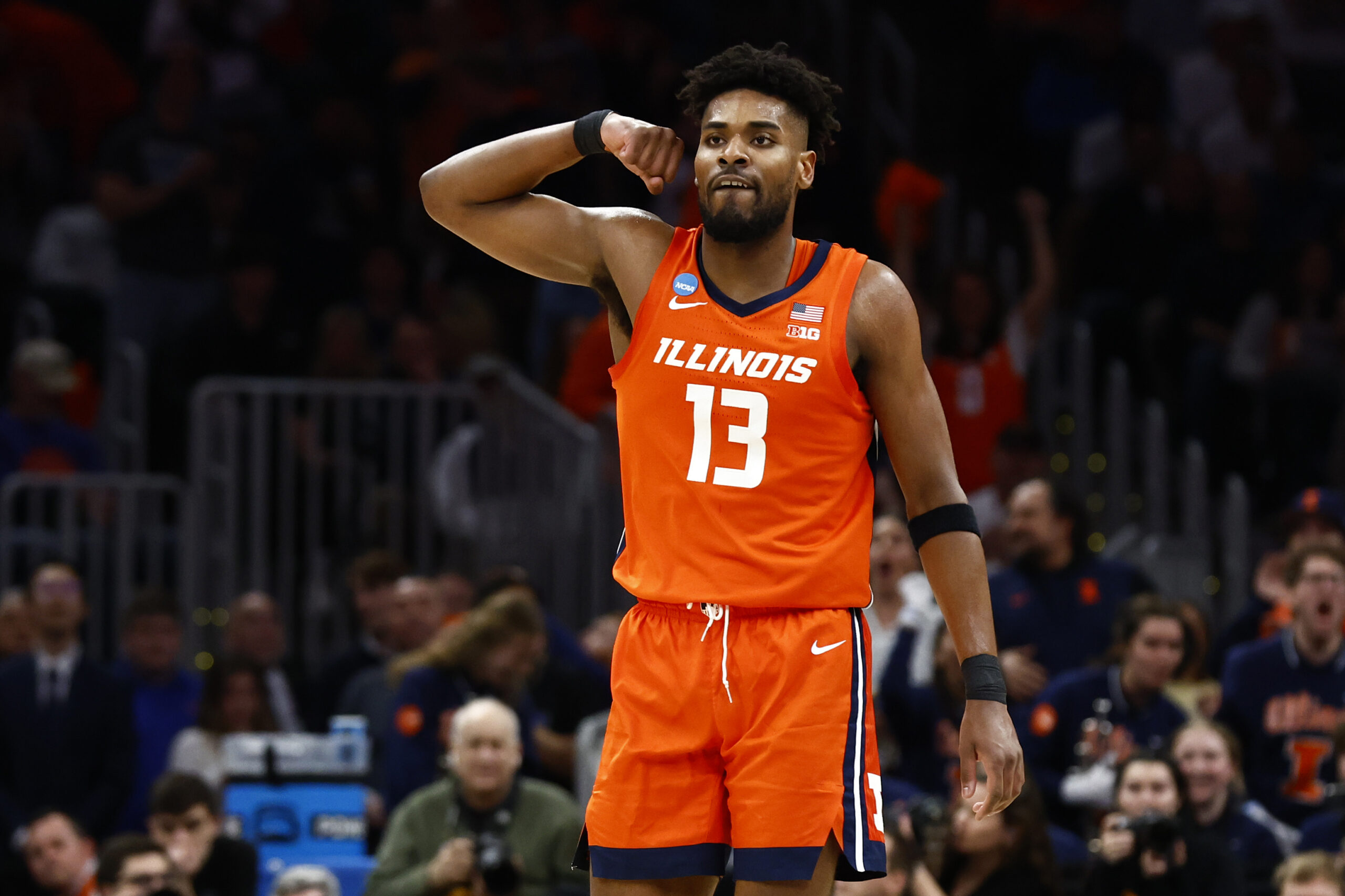 Former Illinois basketball forward, Quincy Guerrier, flexes his muscles