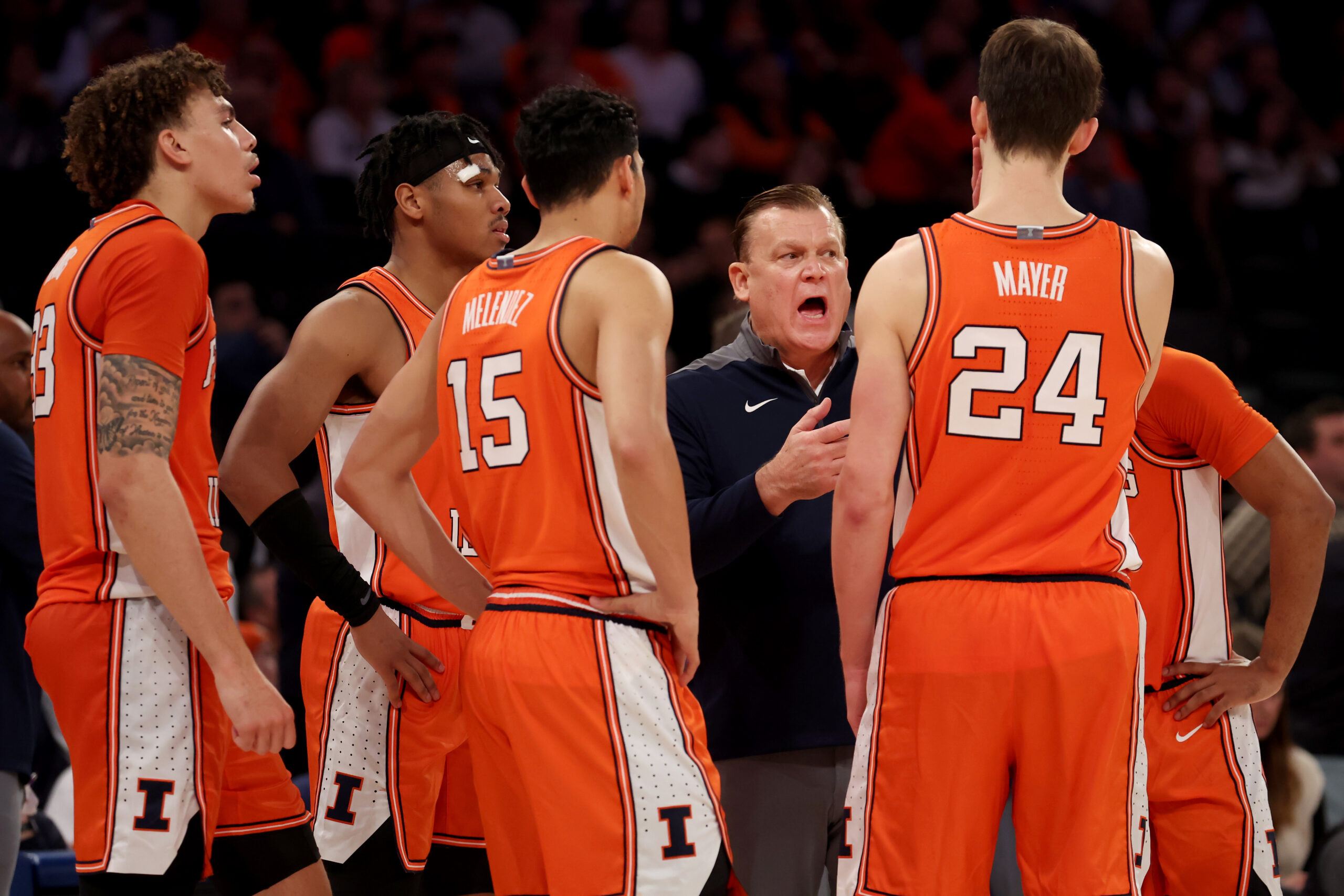 Illinois basketball head coach Brad Underwood talks to his team.