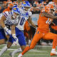 Sep 7, 2024; Champaign, Illinois, USA; Illinois Fighting Illini defensive back Xavier Scott (14) intercepts the ball in front of Kansas Jayhawks wide receiver Quentin Skinner (0) during the first half at Memorial Stadium. Mandatory Credit: Ron Johnson-Imagn Images