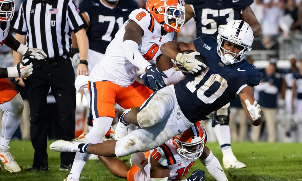 Penn State running back Nick Singleton (10) gets tripped up while carrying the ball in the fourth quarter of a Big Ten football game against Illinois, Saturday, Sept. 28, 2024, in State College, Pa.