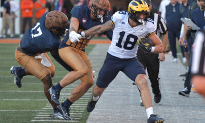 Oct 19, 2024; Champaign, Illinois, USA; Illinois Fighting Illini linebacker Gabe Jacas (17) tries to bring down Michigan Wolverines tight end Colston Loveland (18) during the second half at Memorial Stadium. Mandatory Credit: Ron Johnson-Imagn Images