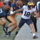 Oct 19, 2024; Champaign, Illinois, USA; Illinois Fighting Illini linebacker Gabe Jacas (17) tries to bring down Michigan Wolverines tight end Colston Loveland (18) during the second half at Memorial Stadium. Mandatory Credit: Ron Johnson-Imagn Images