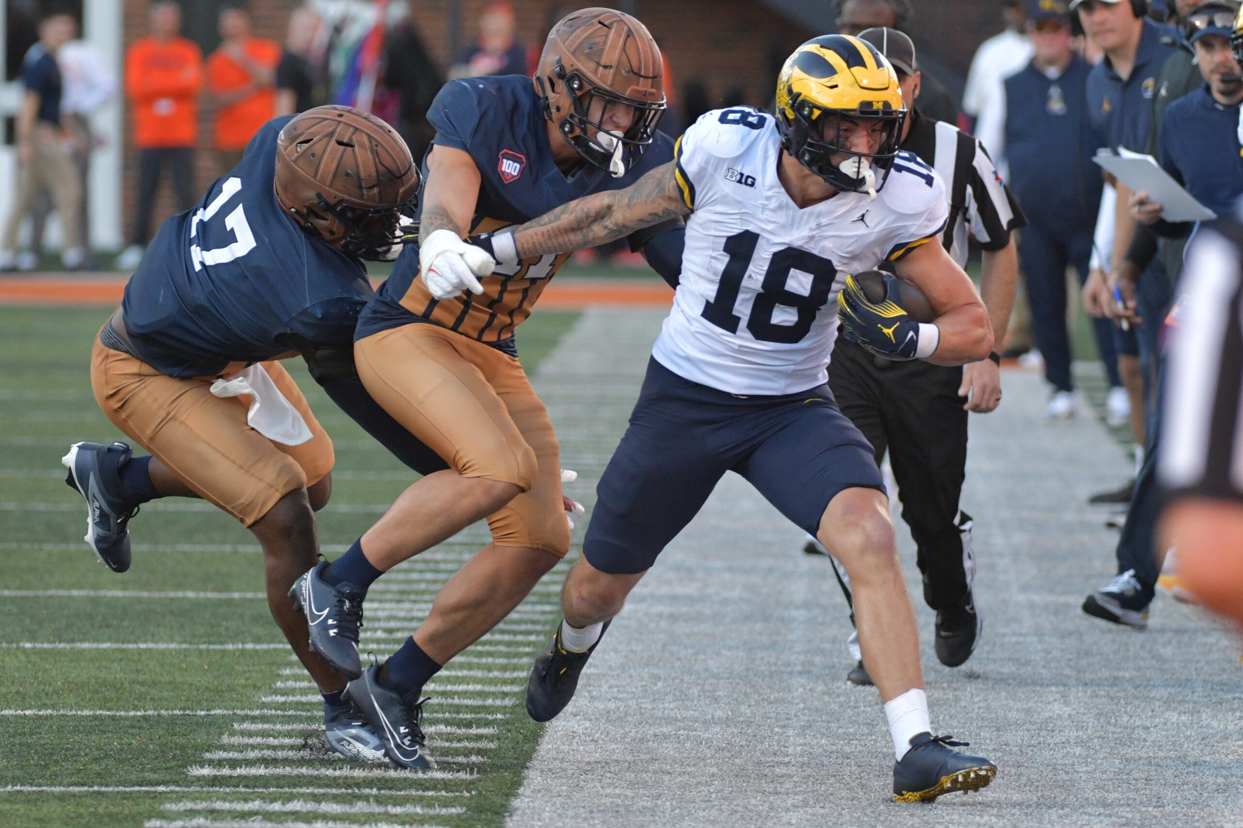 Oct 19, 2024; Champaign, Illinois, USA; Illinois Fighting Illini linebacker Gabe Jacas (17) tries to bring down Michigan Wolverines tight end Colston Loveland (18) during the second half at Memorial Stadium. Mandatory Credit: Ron Johnson-Imagn Images