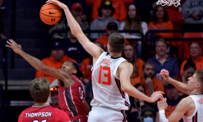 Nov 8, 2024; Champaign, Illinois, USA; Illinois Fighting Illini center Tomislav Ivisic (13) blocks a shot by SIU Edwardsville Cougars guard Brian Taylor II (11) during the first half at State Farm Center. Mandatory Credit: Ron Johnson-Imagn Images