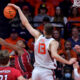 Nov 8, 2024; Champaign, Illinois, USA; Illinois Fighting Illini center Tomislav Ivisic (13) blocks a shot by SIU Edwardsville Cougars guard Brian Taylor II (11) during the first half at State Farm Center. Mandatory Credit: Ron Johnson-Imagn Images