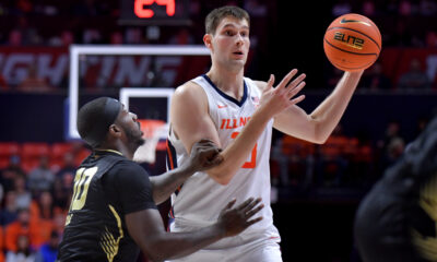 Nov 13, 2024; Champaign, Illinois, USA; Illinois Fighting Illini center Tomislav Ivisic (13) looks to pass against Oakland Golden Grizzlies guard DQ Cole (10) during the first half at State Farm Center. Mandatory Credit: Ron Johnson-Imagn Images