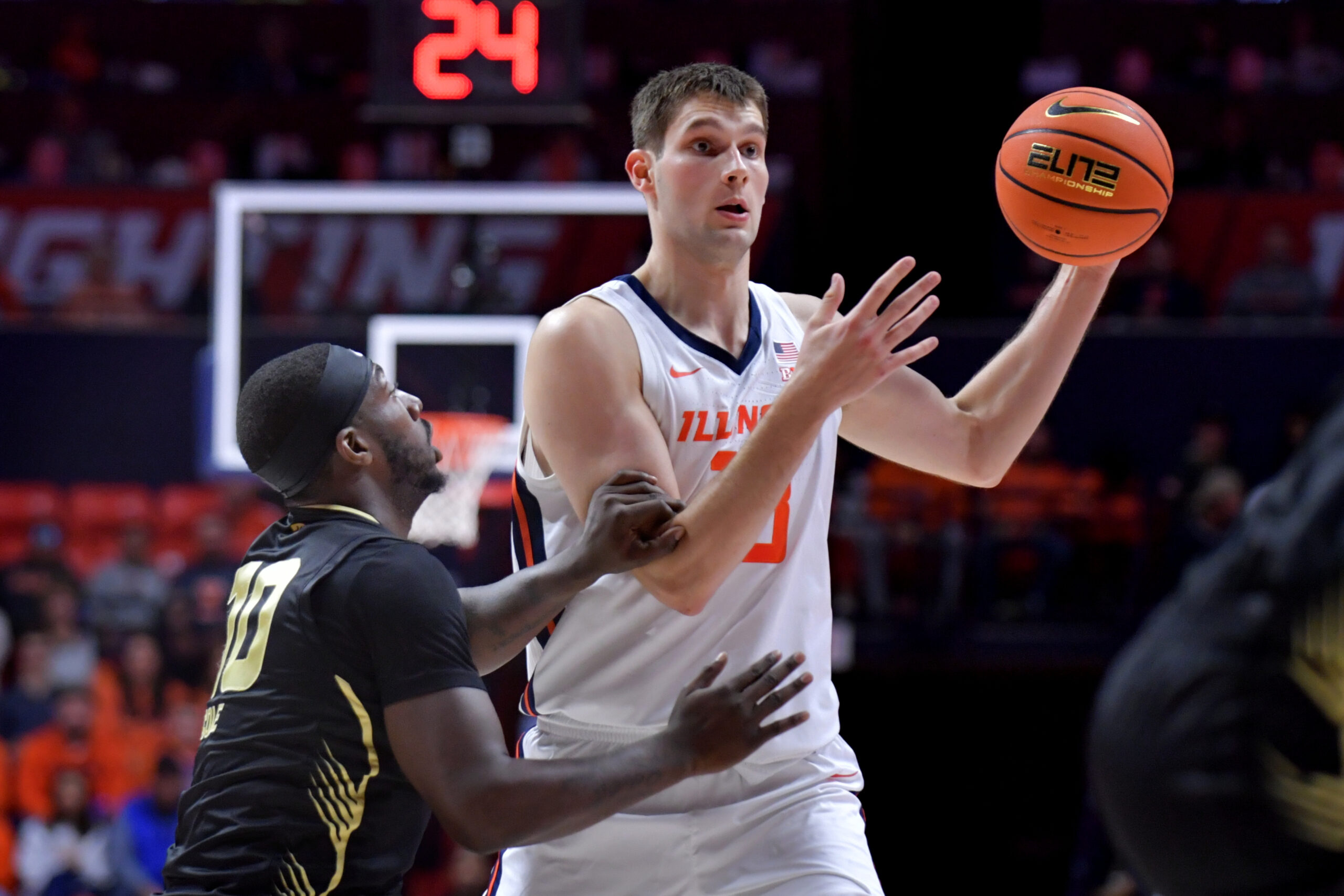 Nov 13, 2024; Champaign, Illinois, USA; Illinois Fighting Illini center Tomislav Ivisic (13) looks to pass against Oakland Golden Grizzlies guard DQ Cole (10) during the first half at State Farm Center. Mandatory Credit: Ron Johnson-Imagn Images