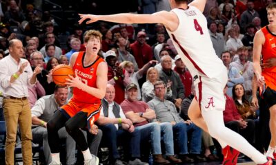 Nov 20, 2024; Birmingham, AL, USA; Illinois guard Kasparas Jakucionis (32) makes a face as he attempts a shot against Alabama forward Grant Nelson (4) in the CM Newton Classic at Legacy Arena. Alabama defeated Illinois 100-87. Mandatory Credit: Gary Cosby Jr.-Tuscaloosa News