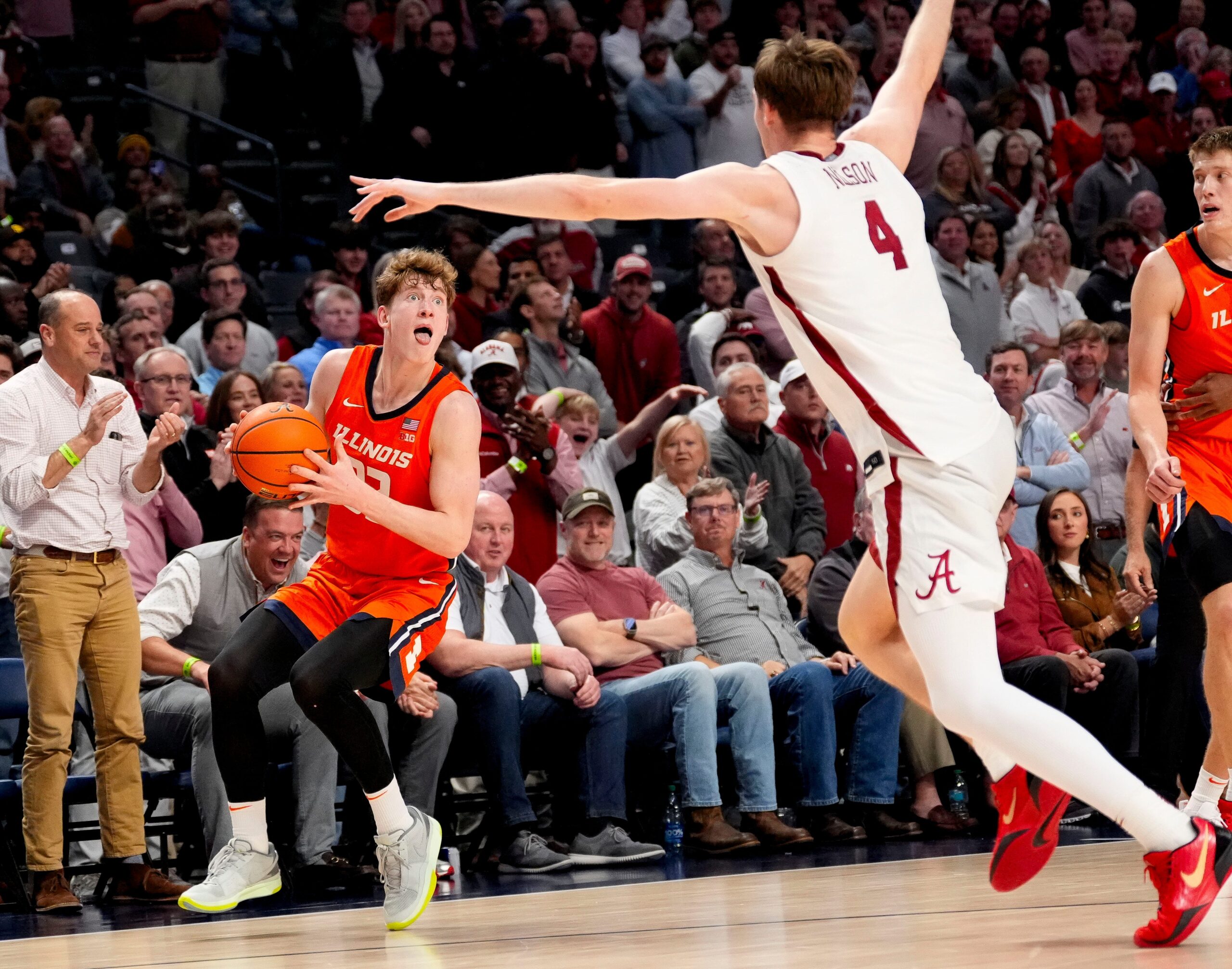 Nov 20, 2024; Birmingham, AL, USA; Illinois guard Kasparas Jakucionis (32) makes a face as he attempts a shot against Alabama forward Grant Nelson (4) in the CM Newton Classic at Legacy Arena. Alabama defeated Illinois 100-87. Mandatory Credit: Gary Cosby Jr.-Tuscaloosa News