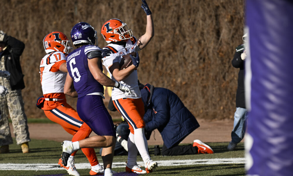 Nov 30, 2024; Chicago, Illinois, USA; Illinois Fighting Illini running back Aidan Laughery (21) scores a touchdown against the Northwestern Wildcats during the second half at Wrigley Field. Mandatory Credit: Matt Marton-Imagn Images