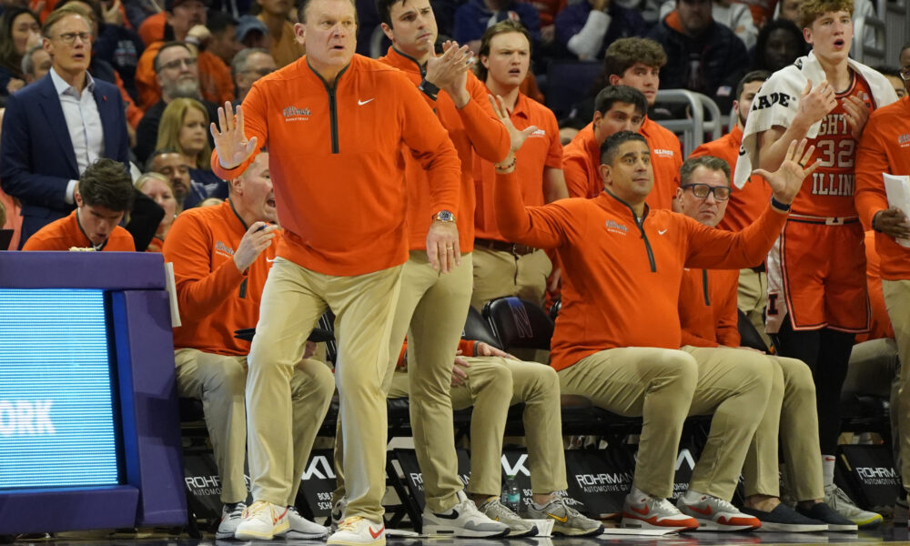 Illinois basketball and their coaching staff watches a play vs Northwestern.