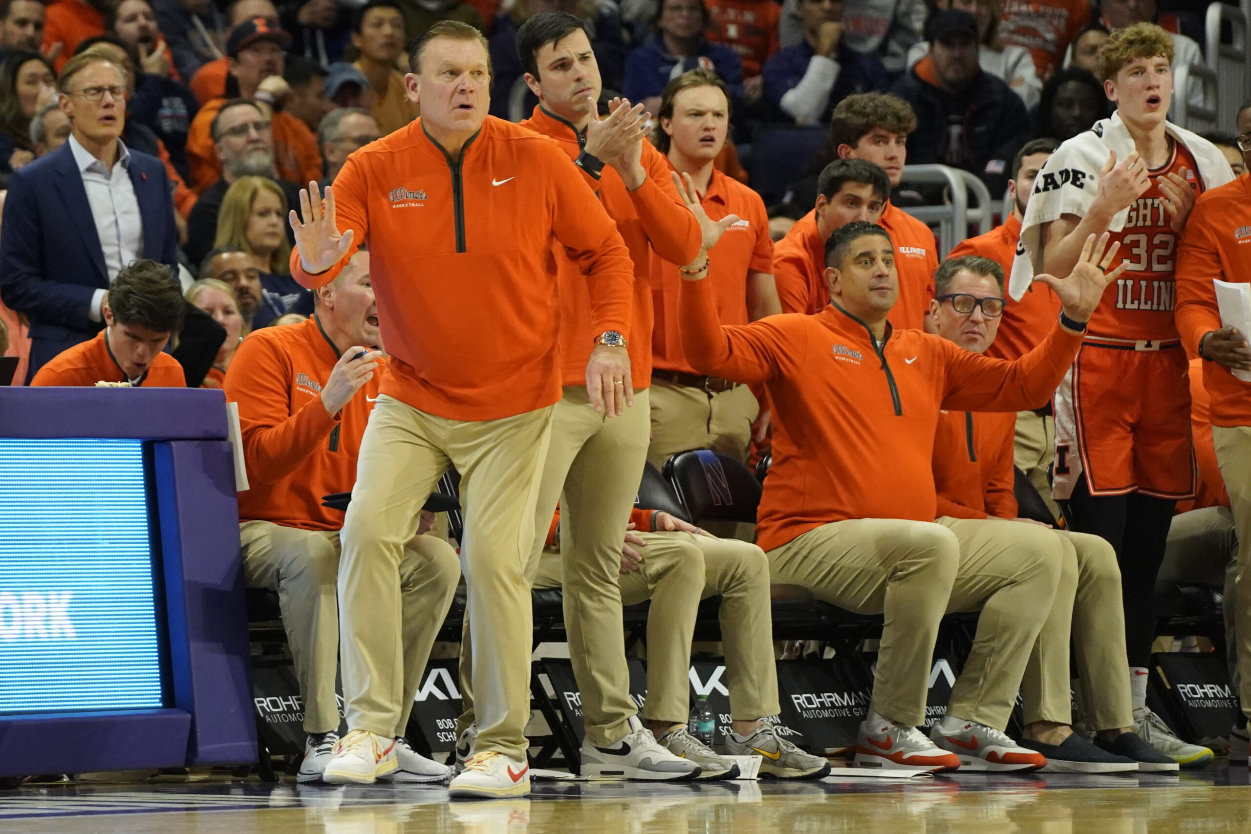 Illinois basketball and their coaching staff watches a play vs Northwestern.