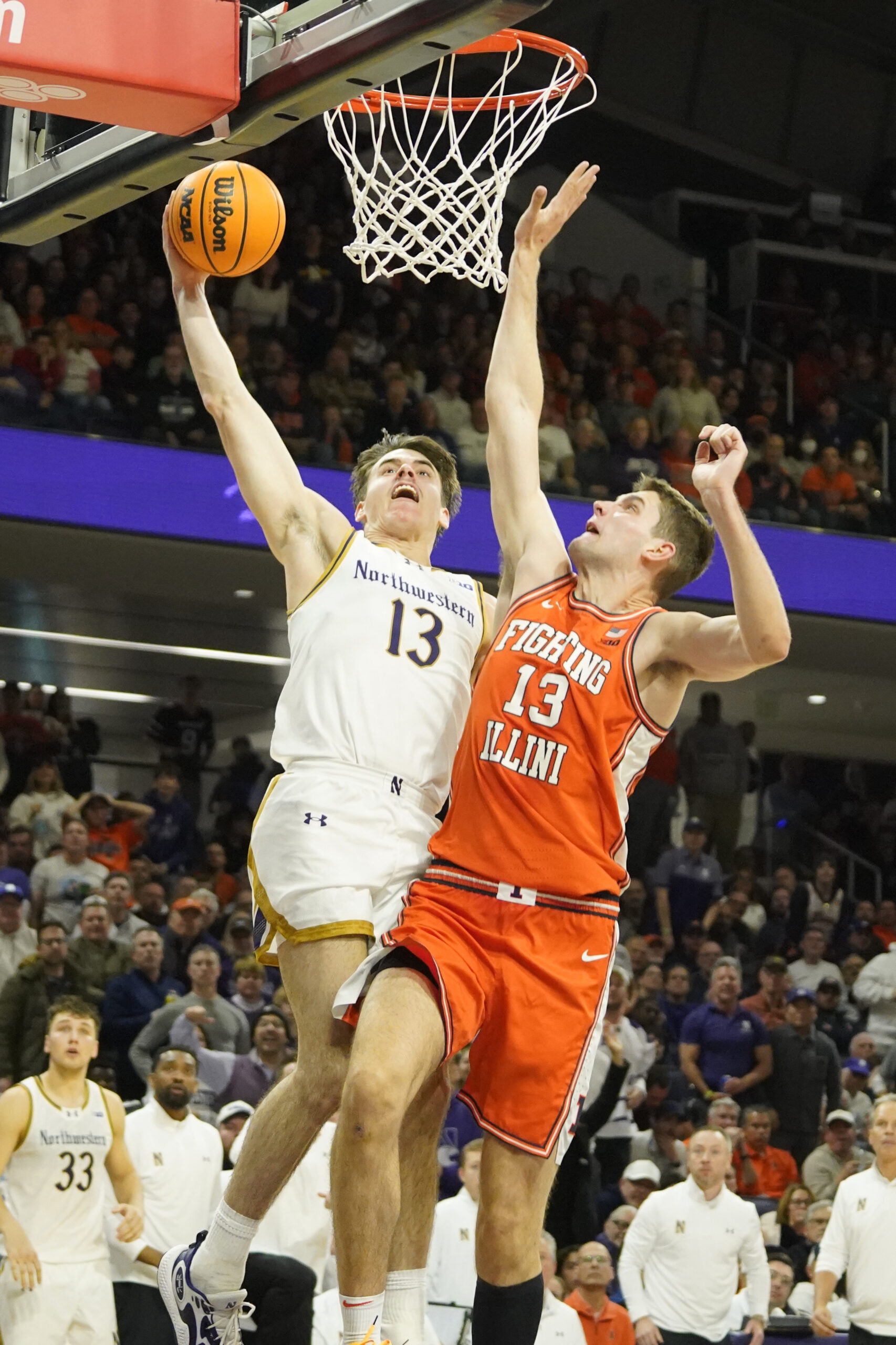 Dec 6, 2024; Evanston, Illinois, USA; Illinois Fighting Illini center Tomislav Ivisic (13) defends Northwestern Wildcats guard Brooks Barnhizer (13) during the second half at Welsh-Ryan Arena. Mandatory Credit: David Banks-Imagn Images