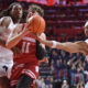 Dec 10, 2024; Champaign, Illinois, USA; Illinois Fighting Illini guard Kylan Boswell (4) reaches for the ball as Wisconsin Badgers guard Max Klesmit (11) drives to the basket during the second half at State Farm Center. Mandatory Credit: Ron Johnson-Imagn Images