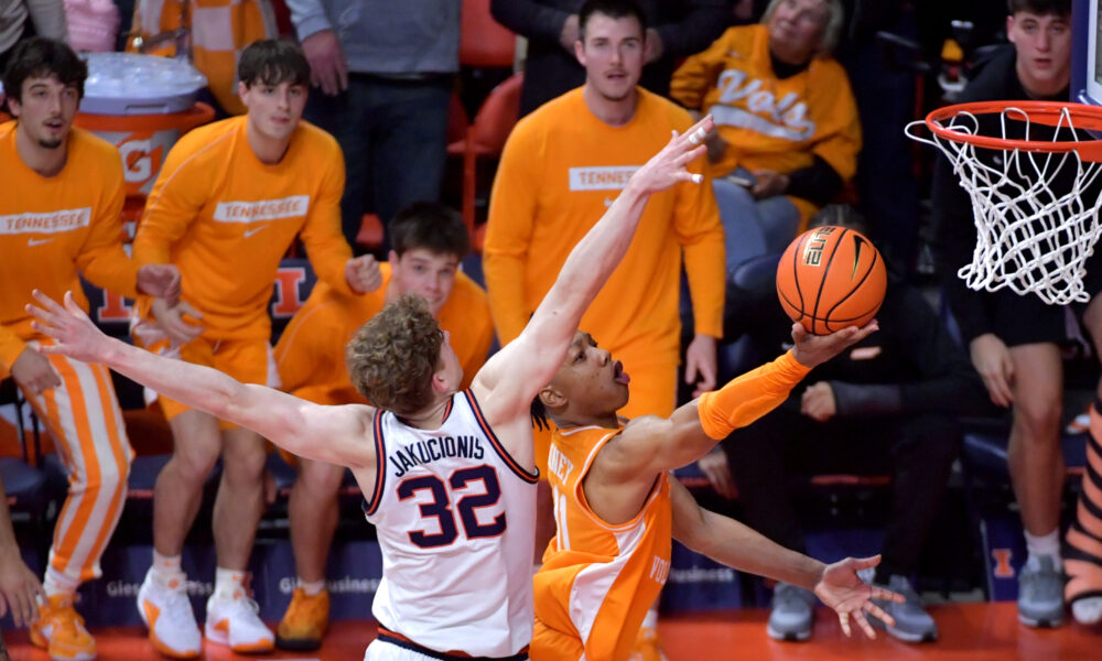 Dec 14, 2024; Champaign, Illinois, USA; Tennessee Volunteers guard Jordan Gainey (11) drives to the basket and scores as Illinois Fighting Illini guard Kasparas Jakucionis (32) defends in the final seconds at State Farm Center. Mandatory Credit: Ron Johnson-Imagn Images