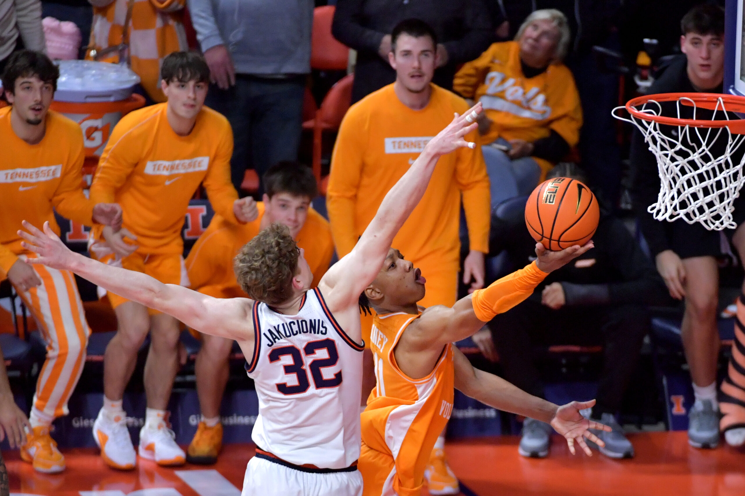 Dec 14, 2024; Champaign, Illinois, USA; Tennessee Volunteers guard Jordan Gainey (11) drives to the basket and scores as Illinois Fighting Illini guard Kasparas Jakucionis (32) defends in the final seconds at State Farm Center. Mandatory Credit: Ron Johnson-Imagn Images