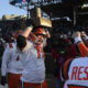 Illinois Football lineman holds up the Land of Lincoln trophy.