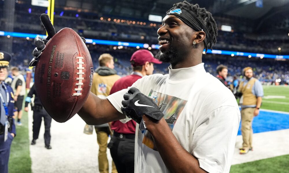 Former Illini Kerby Joseph signing autographs for Detroit Lions fans.