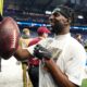 Former Illini Kerby Joseph signing autographs for Detroit Lions fans.