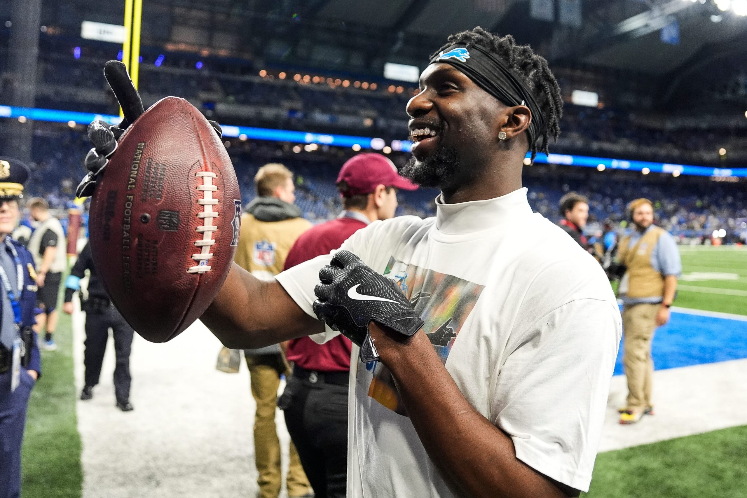 Former Illini Kerby Joseph signing autographs for Detroit Lions fans.