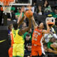 Jan 2, 2025; Eugene, Oregon, USA; Illinois Fighting Illini guard Tre White (22) and center Tomislav Ivisic (13) defend a shot by Oregon Ducks forward Supreme Cook (7) during the second half at Matthew Knight Arena. Mandatory Credit: Craig Strobeck-Imagn Images