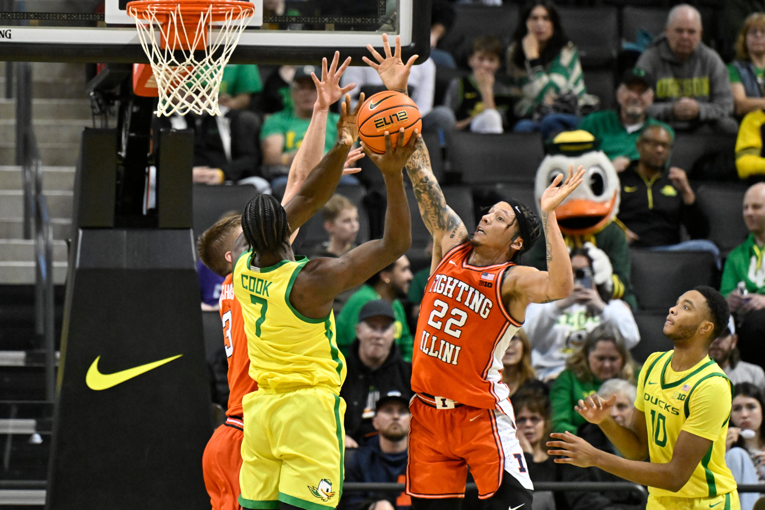 Jan 2, 2025; Eugene, Oregon, USA; Illinois Fighting Illini guard Tre White (22) and center Tomislav Ivisic (13) defend a shot by Oregon Ducks forward Supreme Cook (7) during the second half at Matthew Knight Arena. Mandatory Credit: Craig Strobeck-Imagn Images