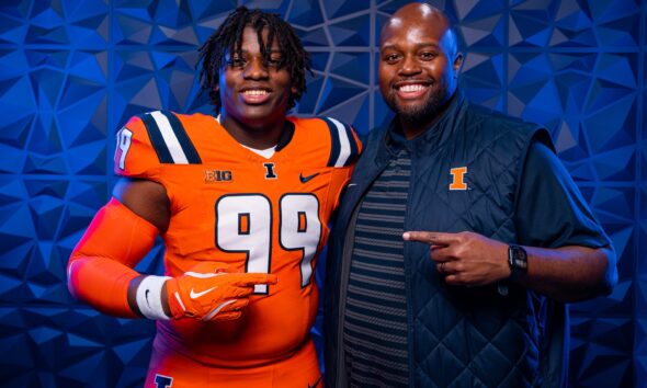 news: illinois football hosted King Liggins for a visit as he poses with Defensive line coach, Terrance Jamison.
