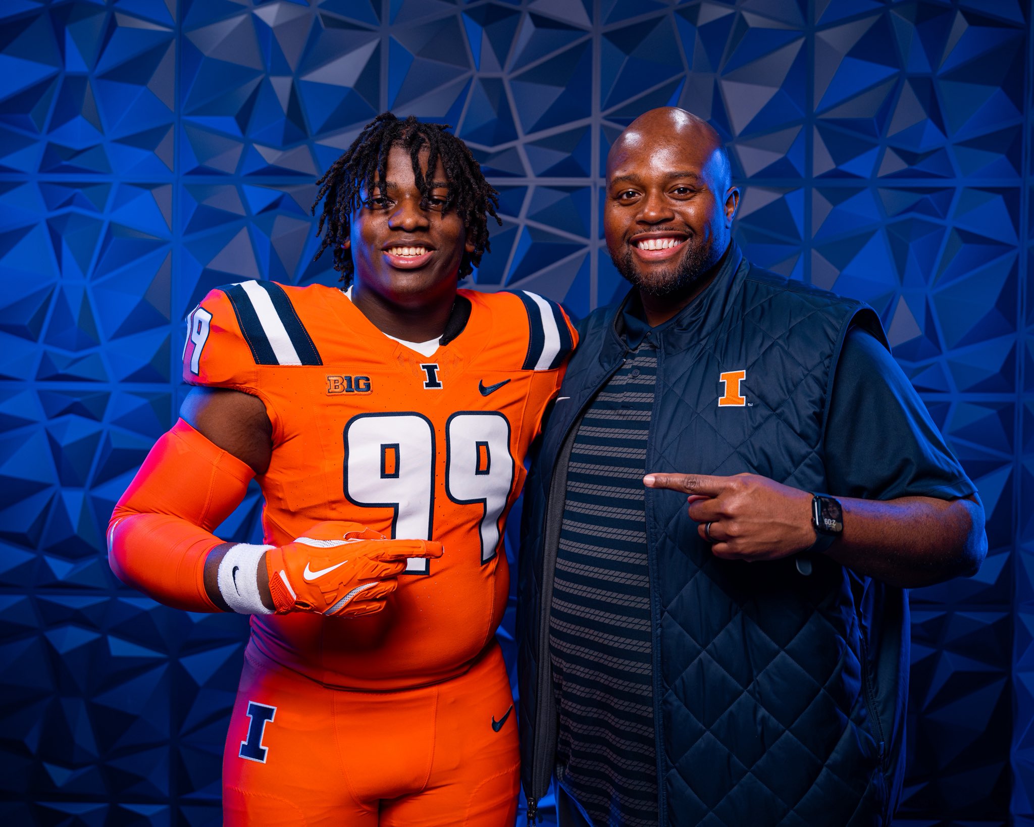 news: illinois football hosted King Liggins for a visit as he poses with Defensive line coach, Terrance Jamison.