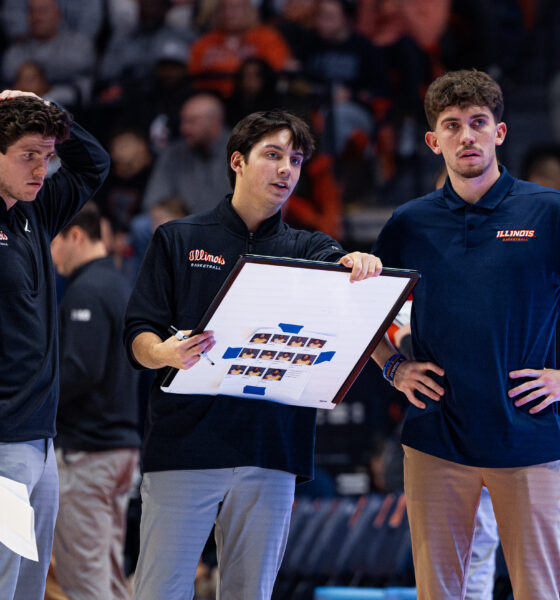 Illinois basketball support staff drawing up a play.