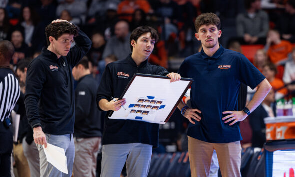 Illinois basketball support staff drawing up a play.